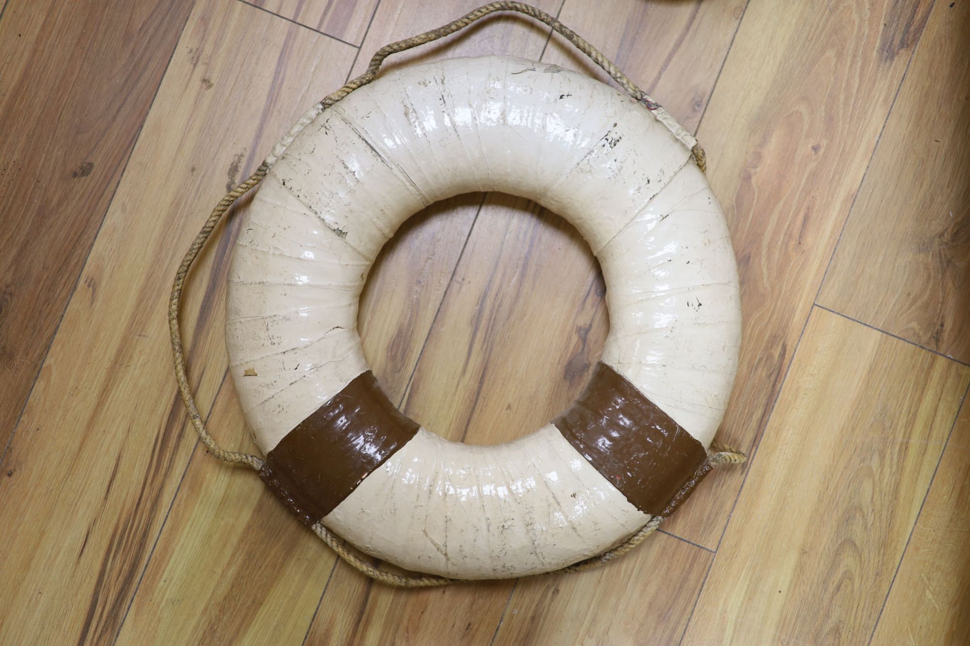 A taxidermic stags head with antlers (a.f.) and a vintage life saving ring (2)